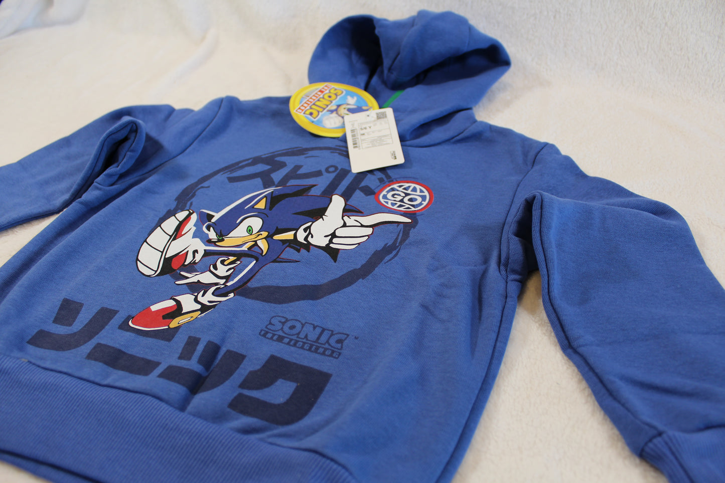 Blue hooded sweatshirt featuring a dynamic Sonic the Hedgehog graphic and Japanese text, labeled as 110/116 Pullover Sonic.
