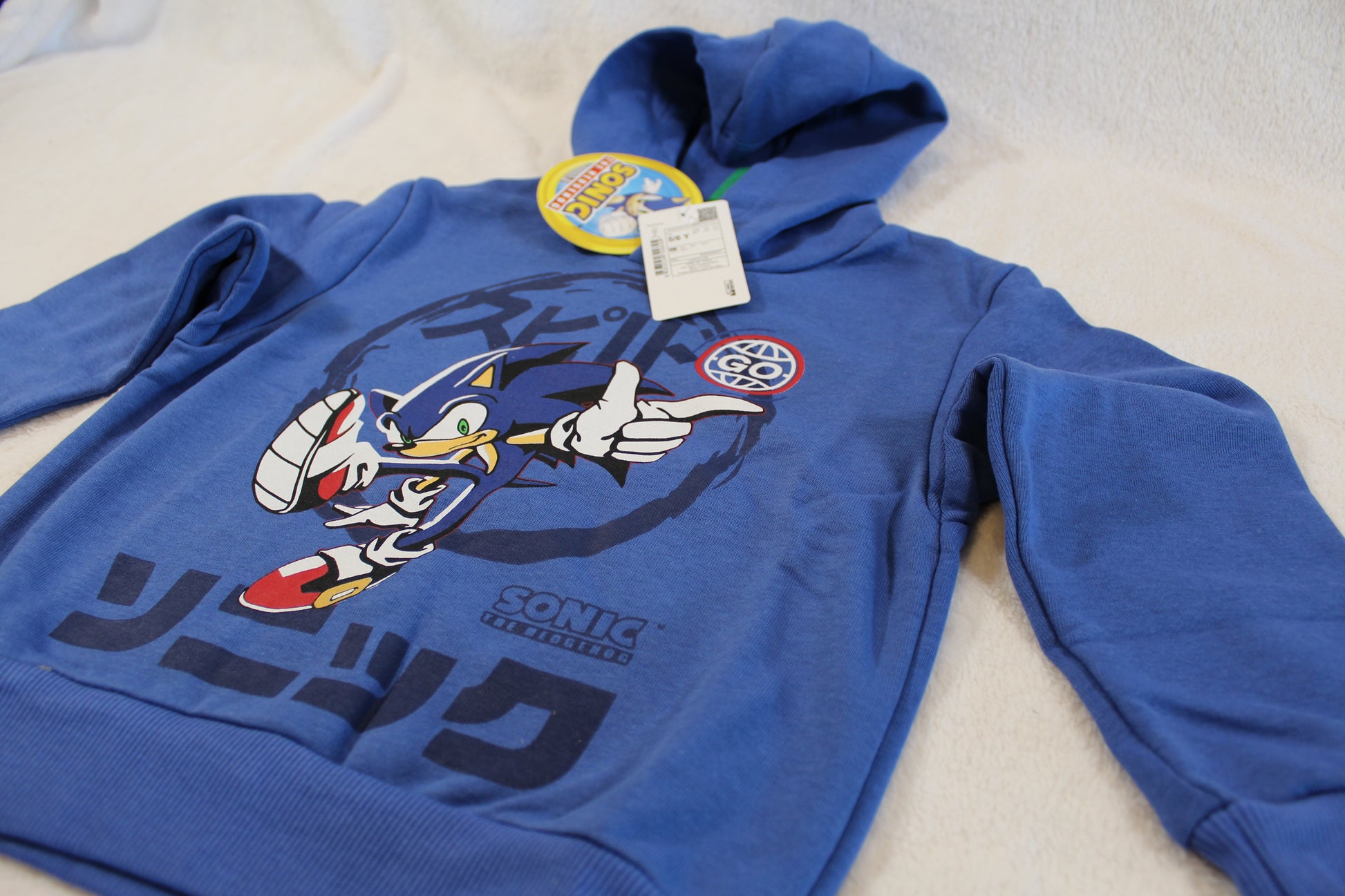 Blue hooded sweatshirt featuring a dynamic Sonic the Hedgehog graphic and Japanese text, labeled as 110/116 Pullover Sonic.
