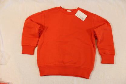 Bright orange crewneck sweatshirt with ribbed cuffs and hem, displayed flat with a small white tag visible, labeled 116/122 Uni Pullover.
