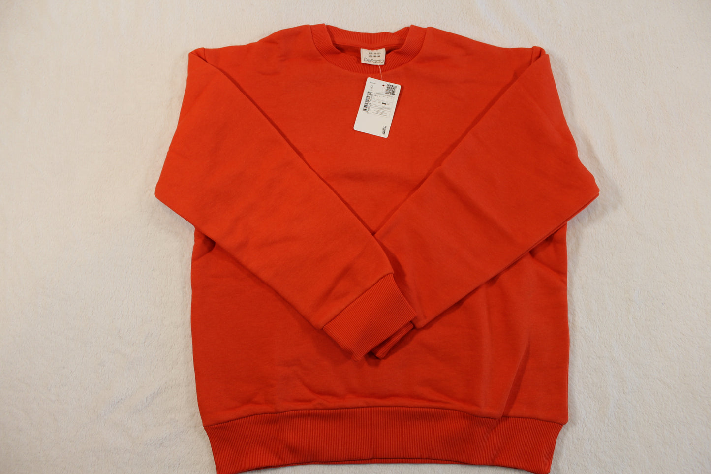 140/146 Uni Pullover Jungs in a vibrant orange color, laid flat to display its long sleeves and simple pullover design.