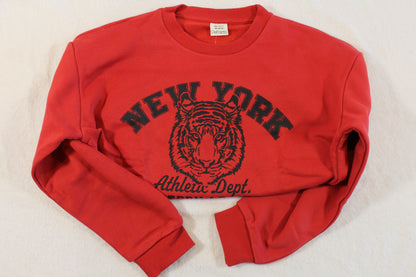 Red pullover with black tiger graphic and "New York" text, featuring a cropped style and long sleeves in the 140/146 Tiger Style Pullover design.