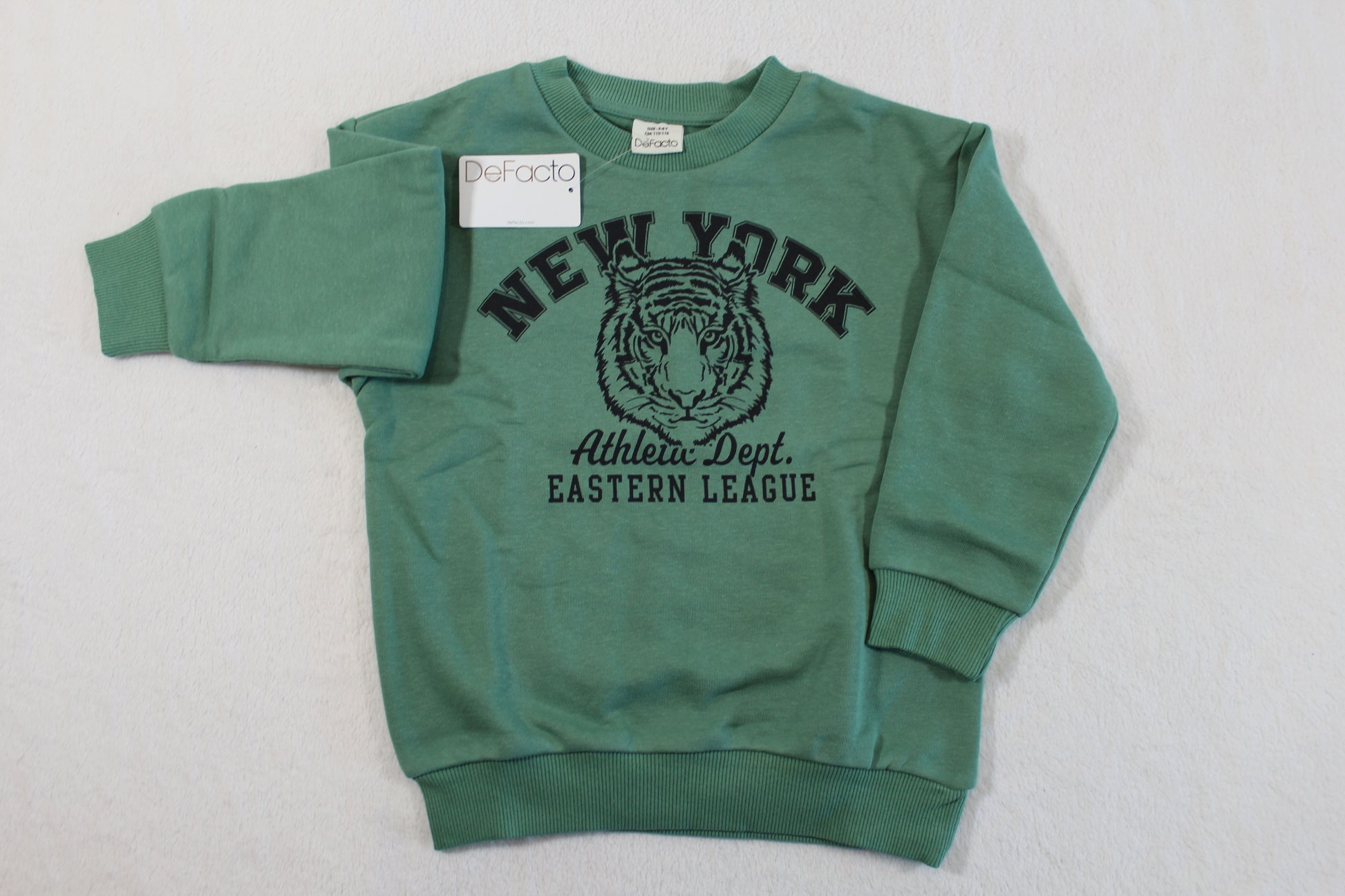 Green sweatshirt with black tiger graphic and New York text on front, styled as 110/116 Tiger Style, suitable for casual wear.