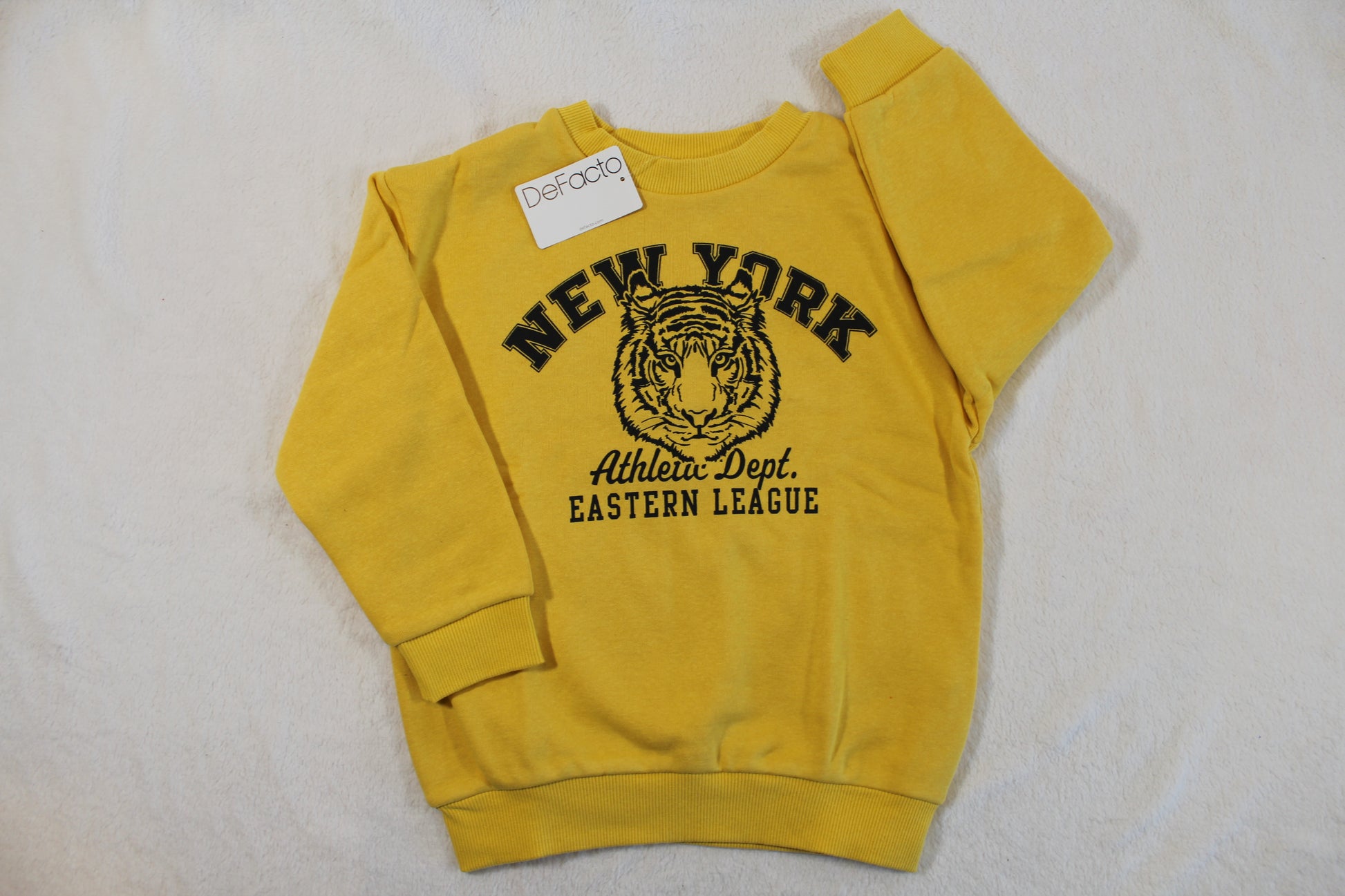 110/116 Tiger Style Pullover in yellow with black New York and tiger graphic on the front, featuring long sleeves and a crew neck style.