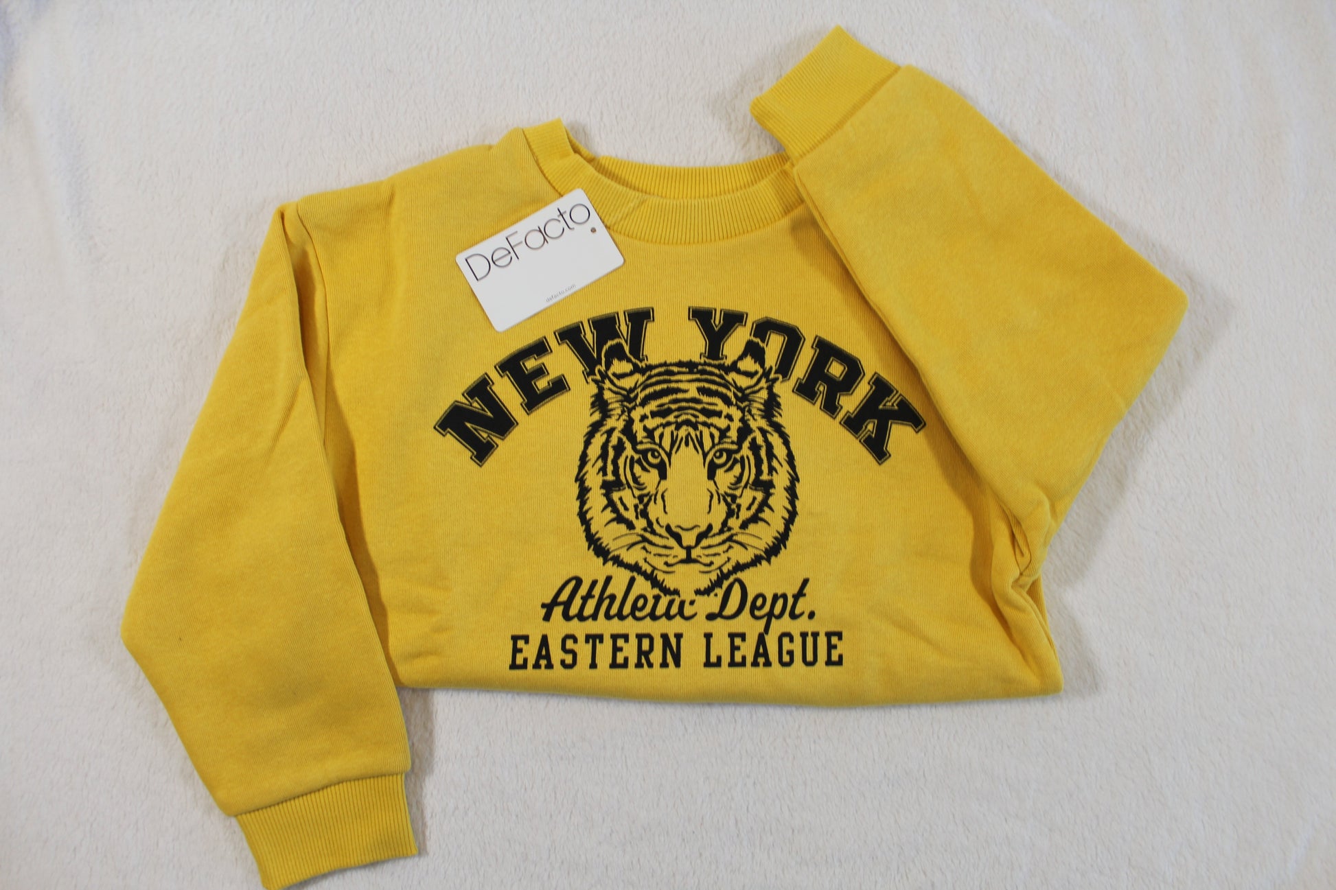 Bright yellow 110/116 Tiger Style Pullover featuring a bold tiger graphic with New York Athletic Dept. Eastern League text on the front, laid flat on a light surface.